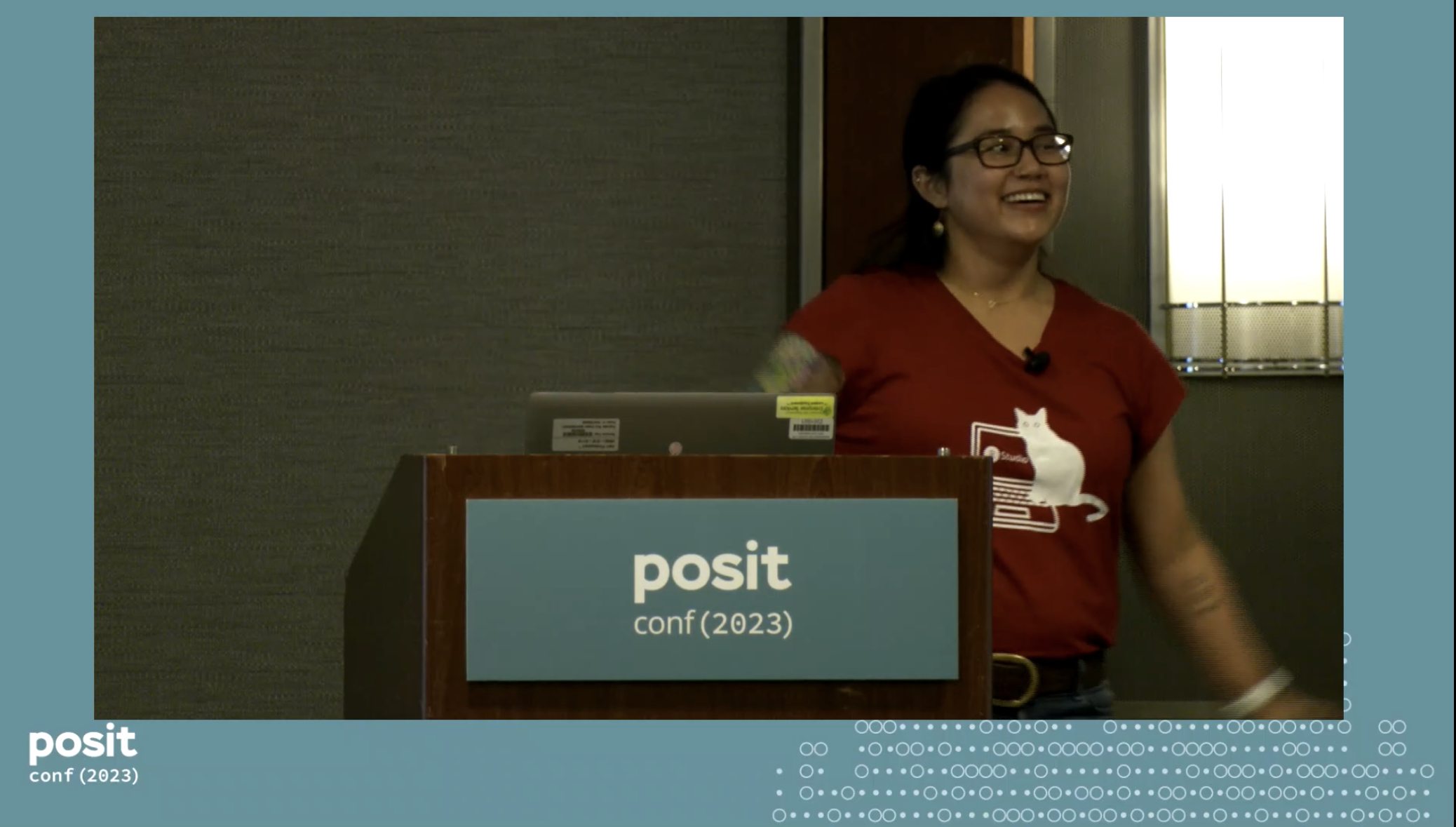 Me smiling while presenting at posit::conf(2023).